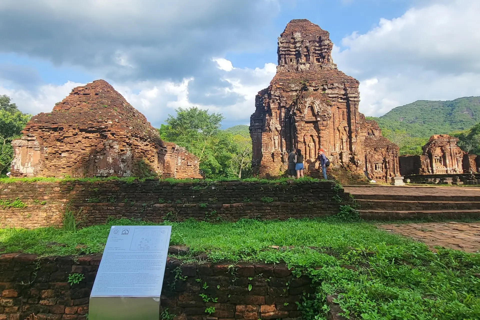 Brick temple remains along a visitor path at My Son Sanctuary